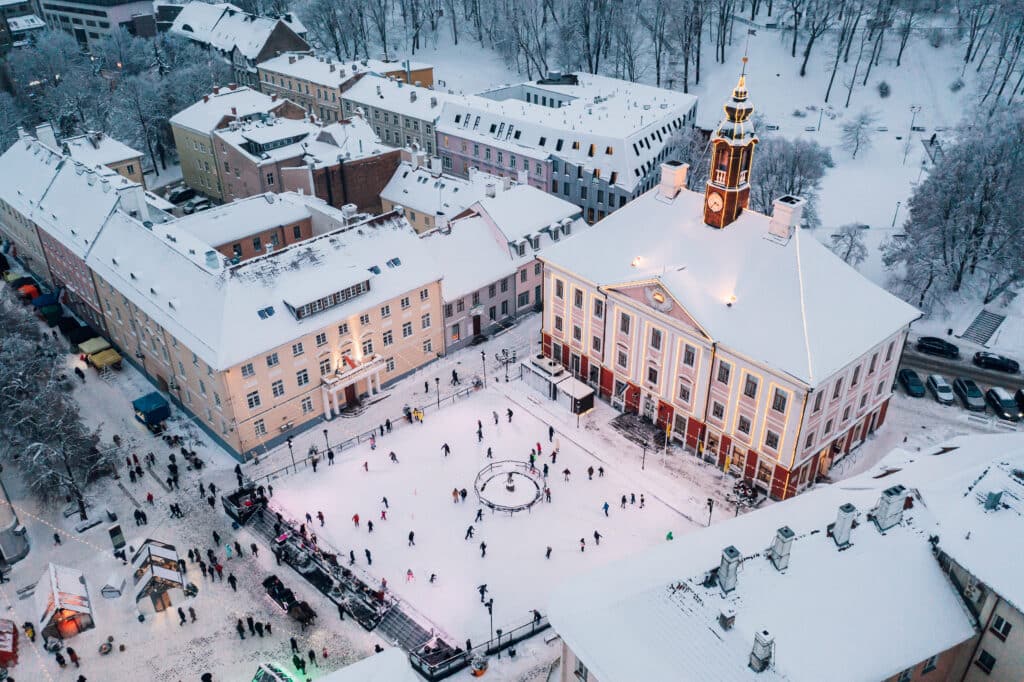 Winter Tartu Town Hall Square, illuminated town hall and ice rink