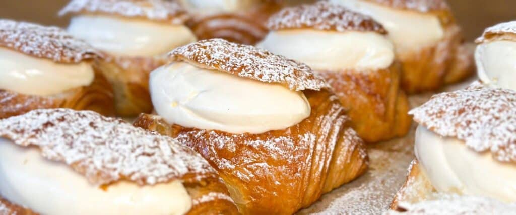 Shrove Tuesday croissants with cream filling and powdered sugar