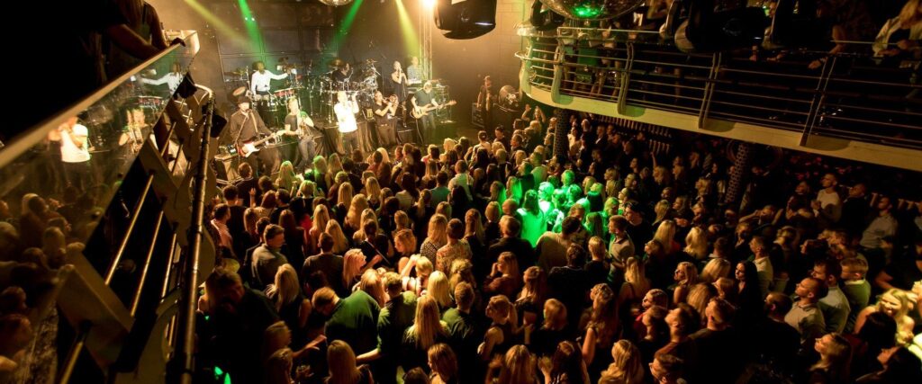 Public dancing and enjoying the concert at Tartu Club Illusion.