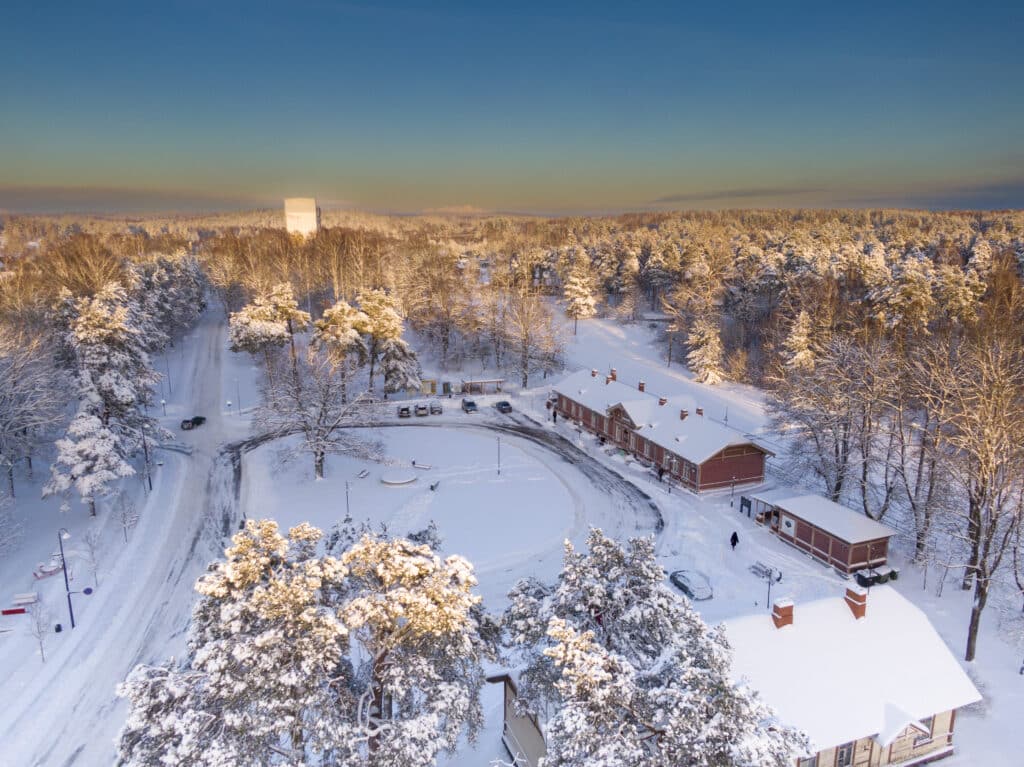 Elva station building in winter with snow, drone view