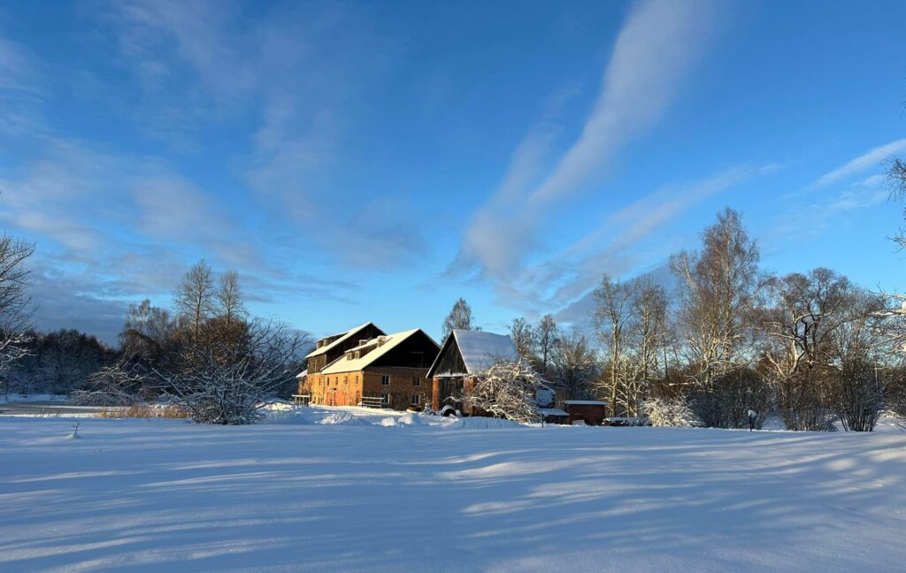 Hellenurme Watermill Museum in snowy Southern Estonia – historical mill building in winter light