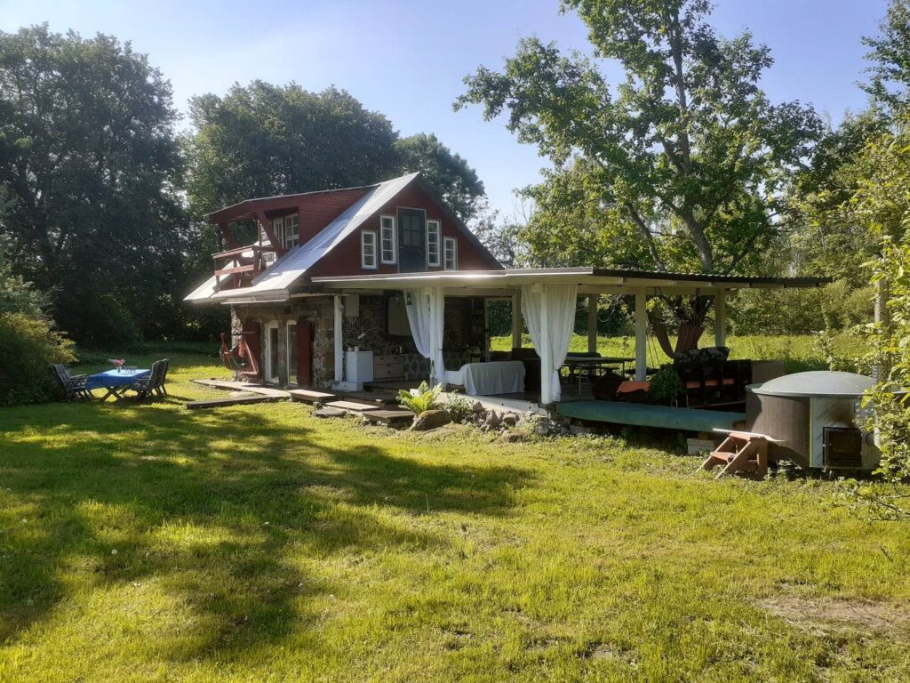 Toreski Farm holiday home with a terrace and garden furniture in the greenery of Southern Estonia.